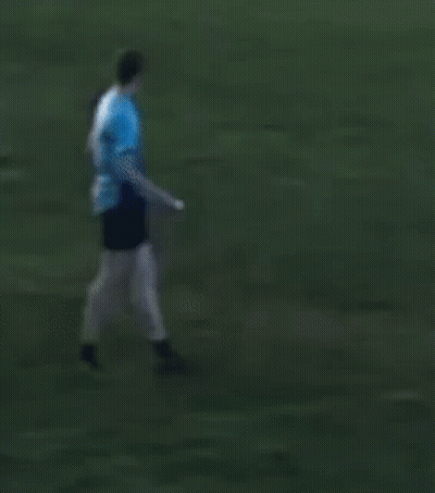 Man In Blue Shirt Kicking Frisbee GIF