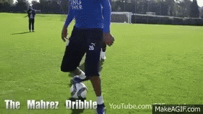 Man In Blue Shirt Kicking Soccer Ball GIF
