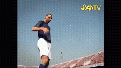 Man In Blue Shirt Kicking Soccer Ball Jogatv GIF