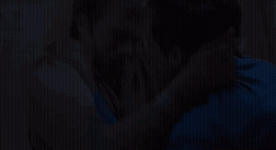 Man In Blue Shirt Kissing Man In Brown Shirt GIF