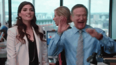 Man In Blue Shirt Laughing Next To Woman In White Jacket GIF