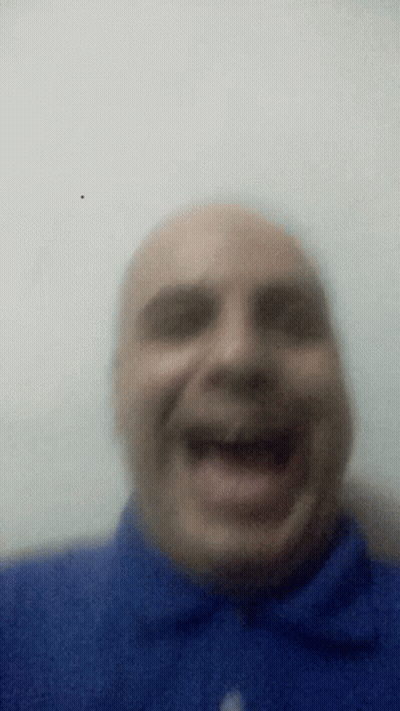 Man In Blue Shirt Laughing With Mouth Open GIF