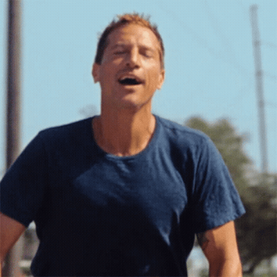 Man In Blue Shirt Laughing With Mouth Open GIF