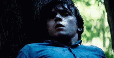 Man In Blue Shirt Leaning Against Tree GIF