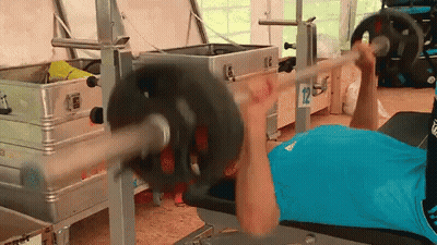 Man In Blue Shirt Lifting Barbell In Gym GIF