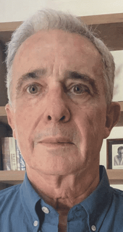 Man In Blue Shirt Looking At Camera GIF