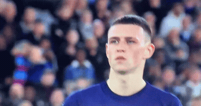 Man In Blue Shirt Looking At Camera GIF