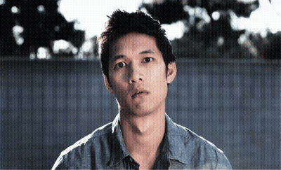 Man In Blue Shirt Looking At Camera GIF
