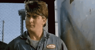 Man In Blue Shirt Looking At Camera GIF