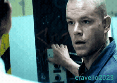Man In Blue Shirt Looking At Photo By Cravello GIF