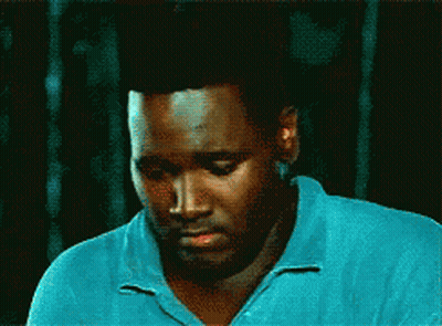 Man In Blue Shirt Looking Down Eyes Closed GIF