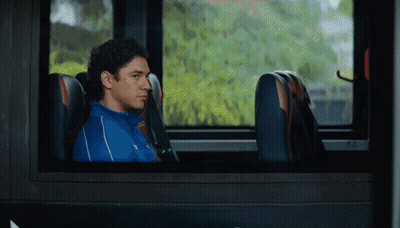Man In Blue Shirt Looking Out Bus Window GIF