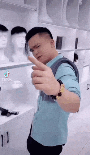 Man In Blue Shirt Makes Funny Face By Wig Display GIF