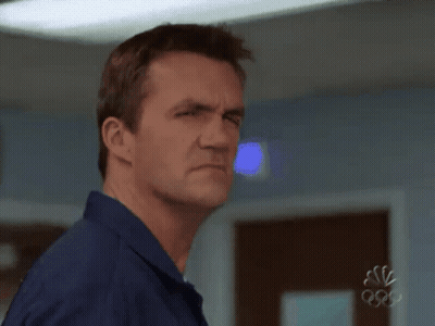 Man In Blue Shirt Making Face At Olympics GIF