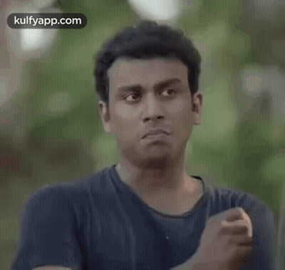 Man In Blue Shirt Making Funny Face And Fist GIF