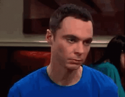 Man In Blue Shirt Making Funny Face At Table GIF