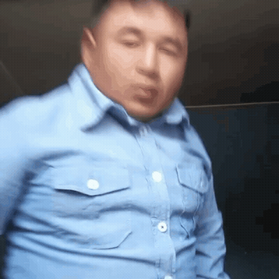 Man In Blue Shirt Making Funny Face At Window GIF