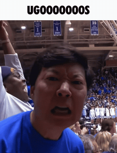 Man In Blue Shirt Making Funny Face In Front Of 2003 Banner GIF