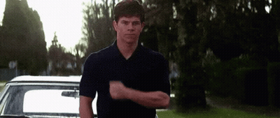 Man In Blue Shirt Making Funny Face In Front Of Car GIF