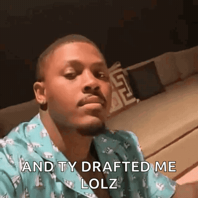 Man In Blue Shirt Making Funny Face On Couch GIF