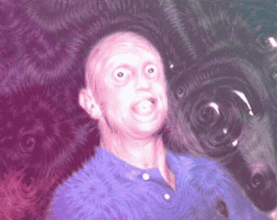 Man In Blue Shirt Making Funny Face On Purple Background GIF
