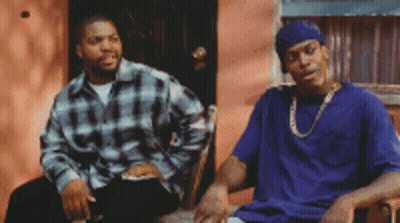 Man In Blue Shirt Next To Man In Plaid Shirt On Porch GIF