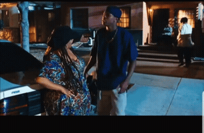 Man In Blue Shirt Next To Woman In Colorful Dress GIF
