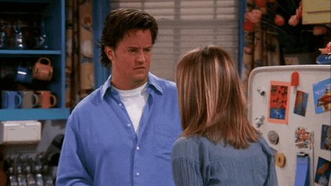 Man In Blue Shirt Next To Woman In Kitchen GIF