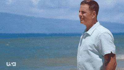Man In Blue Shirt On Beach With USA Logo GIF