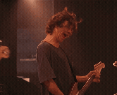 Man In Blue Shirt Playing Bass Guitar GIF