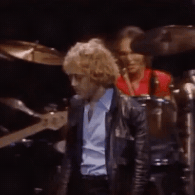 Man In Blue Shirt Playing Guitar, Man In Red Shirt Playing Drum GIF