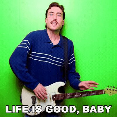 Man In Blue Shirt Playing Guitar Saying Life Is Good Baby GIF