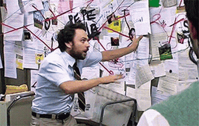 Man In Blue Shirt Pointing At Bulletin Board GIF