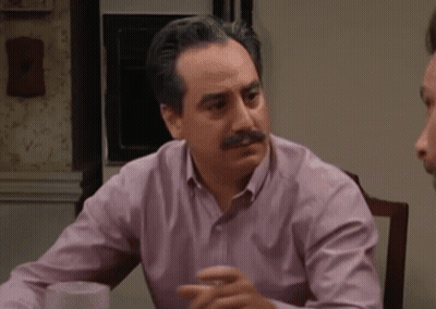 Man In Blue Shirt Pointing At Bulletin Board GIF