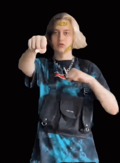 Man In Blue Shirt Pointing At Camera With Black Bag GIF