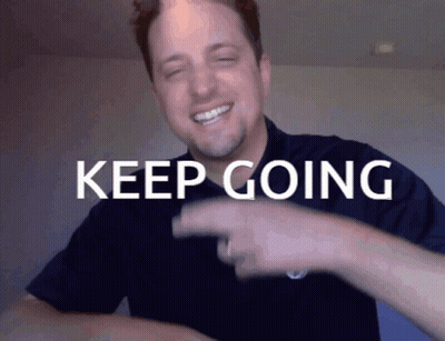 Man In Blue Shirt Pointing At Keep Going GIF