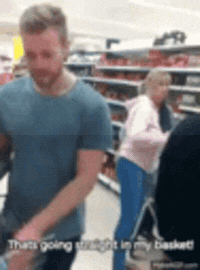 Man In Blue Shirt Pushing Shopping Cart GIF