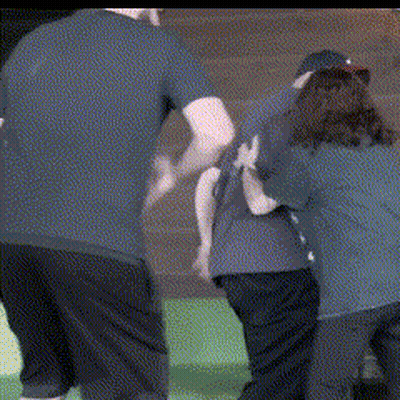 Man In Blue Shirt Pushing Woman In Black Shirt GIF
