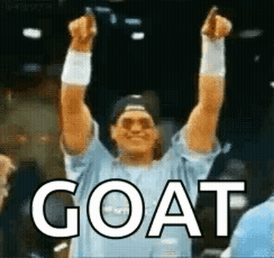 Man In Blue Shirt Raising Arms With Goat GIF