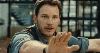 Man In Blue Shirt Reaching Out GIF