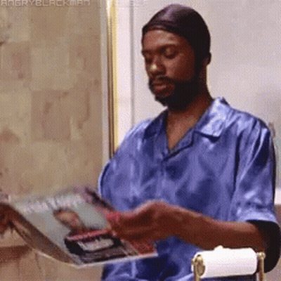 Man In Blue Shirt Reading Angry Blackman Magazine GIF