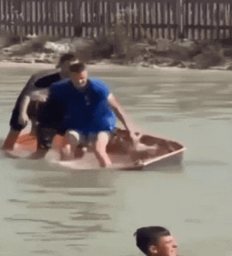 Man In Blue Shirt Riding Boat GIF