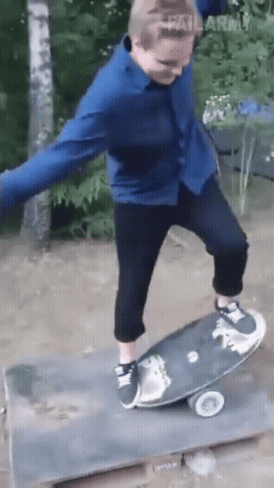 Man in Blue Shirt Riding Skateboard