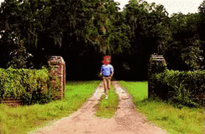 Man In Blue Shirt Running Down Dirt Road GIF