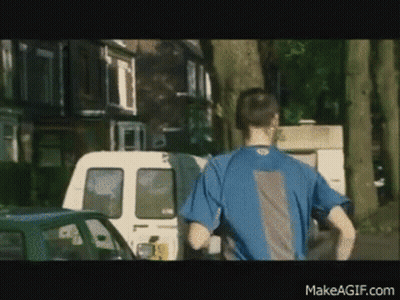 Man In Blue Shirt Running Down Street With Van GIF