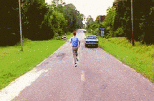 Man In Blue Shirt Running With Car GIF