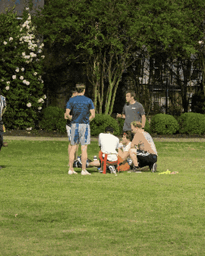 Man In Blue Shirt Saying Georgia In Field With People GIF