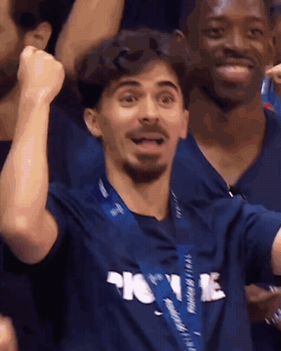 Man In Blue Shirt Saying Home With Fist In Air GIF
