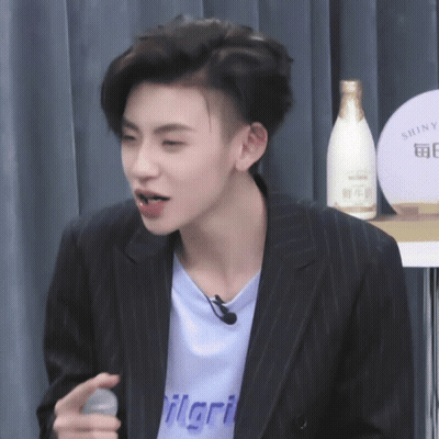 Man In Blue Shirt Saying Ilari Holding Microphone GIF