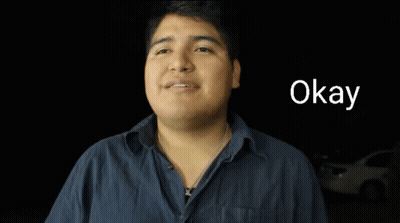 Man in Blue Shirt Saying Okay